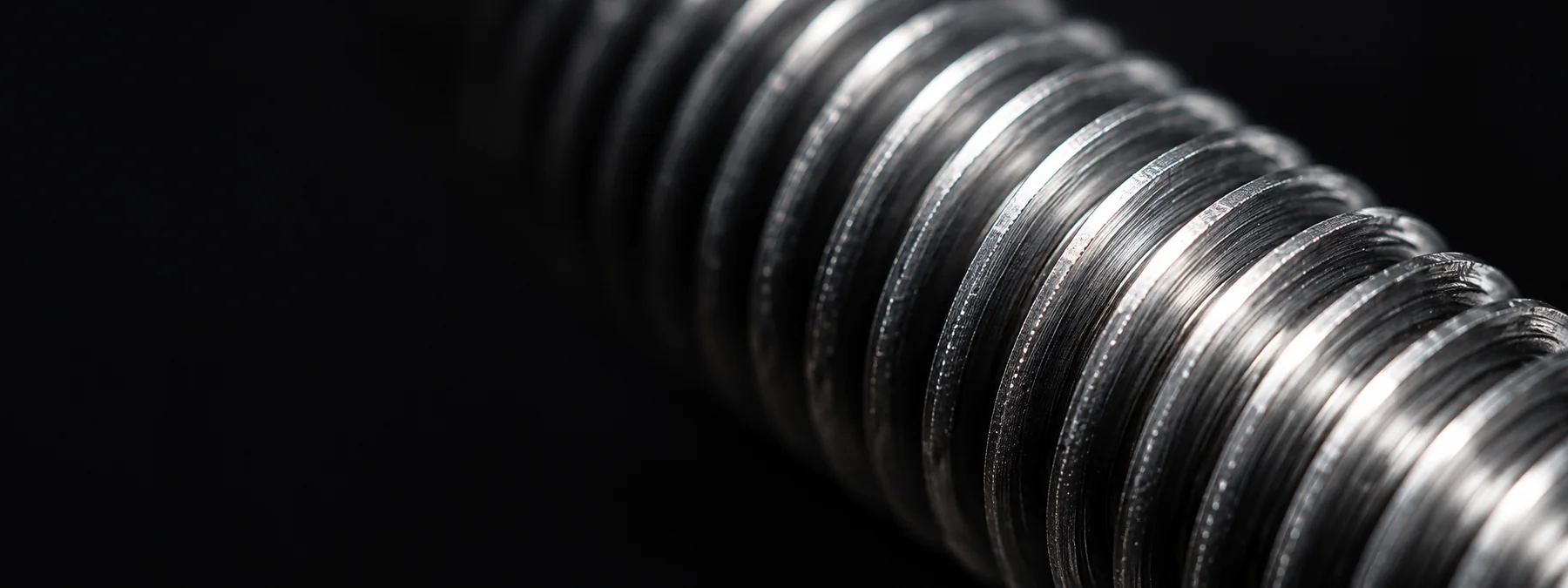 Close-up of the fine machined threads on a steel fastener
